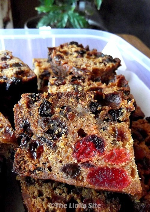 Slices of Christmas cake in a plastic storage container.