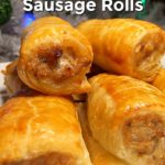 Batch of sausage rolls stacked up on a plate with a Christmas tree in the background and text overlay - Quick and Easy Homemade Sausage Rolls