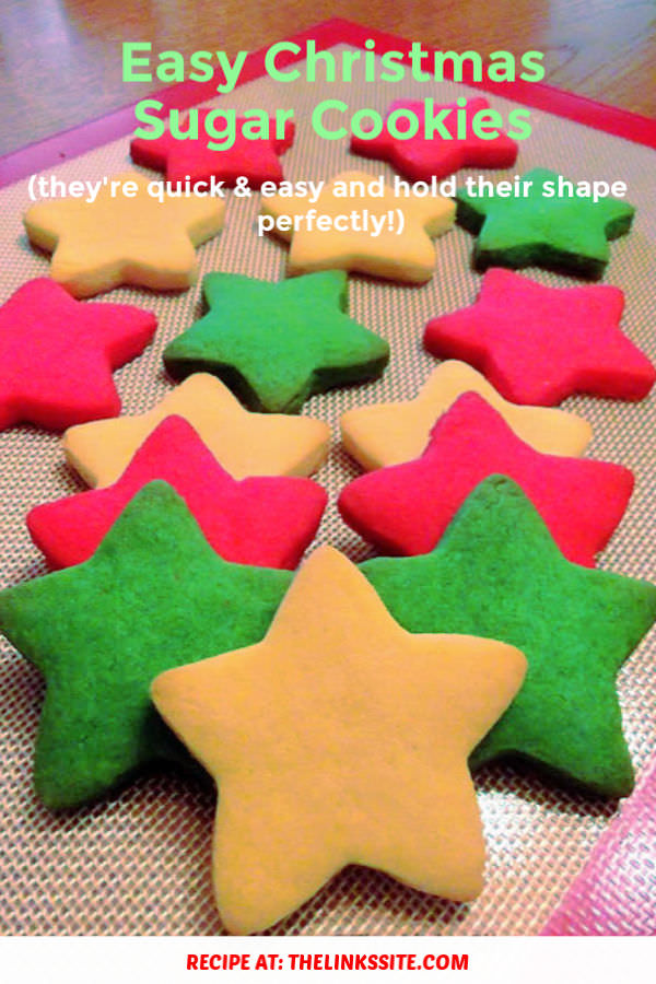 Star shaped cookies coloured white, red, and green on a silicone baking mat. Text overlay says: Easy Christmas Sugar Cookies (they’re quick & easy and hold their shape perfectly!).