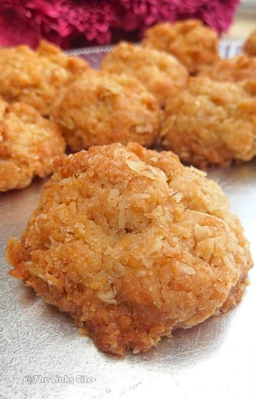 Close up of a single munchie in front of a group on a silver plate.