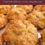 Pinterest image showing homemade munchies on a silver plate with a crimson banner reading ‘Delicious Munchie Cookies; Packed with rolled oats, coconut, and golden syrup!’.