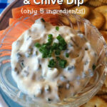 A glass bowl containing dip is placed on a blue and white plate. Carrot sticks and crackers are also placed on the plate. Text overlay says: Quick & Easy Sour Cream & Chive Dip (only 5 ingredients!).