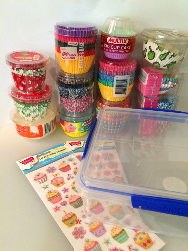 A plastic container and some stickers makes for a very cute storage option for cupcake liners! thelinkssite.com