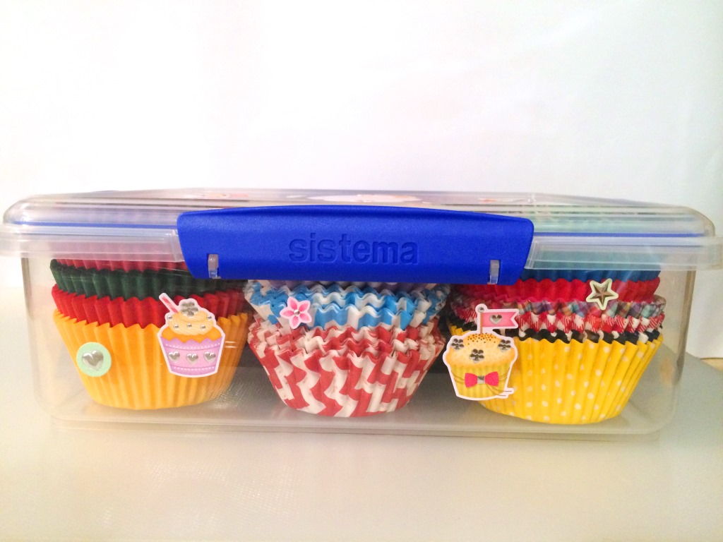 Cupcake liners in a plastic container are so much easier to store. Add some stickers and the look is really cute! thelinkssite.com