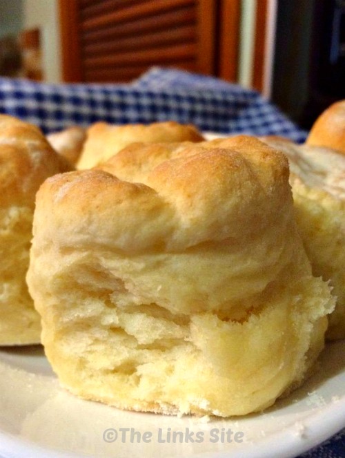 Close up of a batch of plain scones on a white plate. 