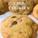 One caramel chocolate chip cookie can be seen in the foreground with more cookies stacked up in the background. Text overlay says: Caramel Chocolate Chip Cookies.