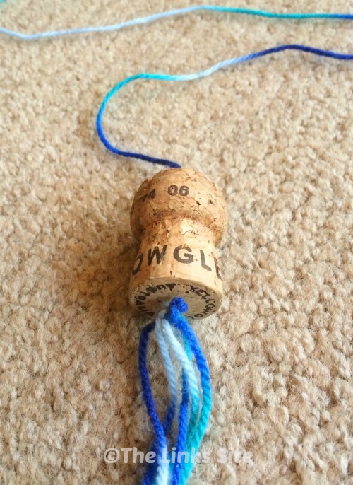 Homemade cat toy on carpet.