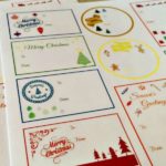 Sheets of Christmas themed gift tags that have not been cut out yet. Text overlay says: Free Printable Christmas Gift Tags.
