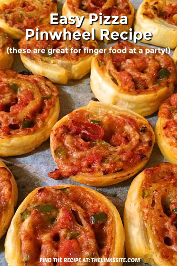Tray of freshly cooked pinwheels. Text overlay says: Easy Pizza Pinwheel Recipe (these are great for finger food at a party!).