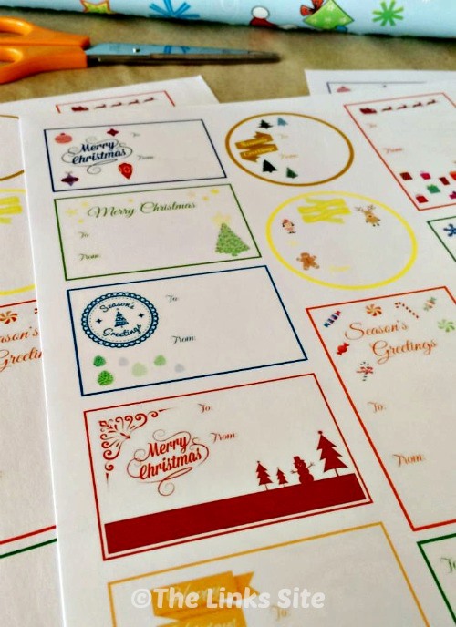 Sheets of Christmas themed gift tags that have not been cut out yet.