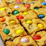 Rows of cookie bars on a piece of baking paper. Text overlay says: Easter Chocolate Chunk Cookie Bars.