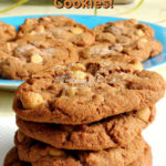 Stack of four cookies on a white paper napkin. A plate containing more cookies as well as a potted plant is seen in the background. Text overlay says: Nutella Peanut Butter Chip Cookies!