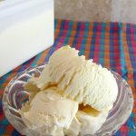 Vanilla ice cream in a small glass bowl.
