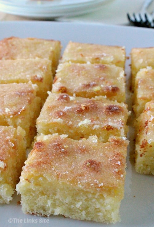 Squares of lemon cake on a white plate.