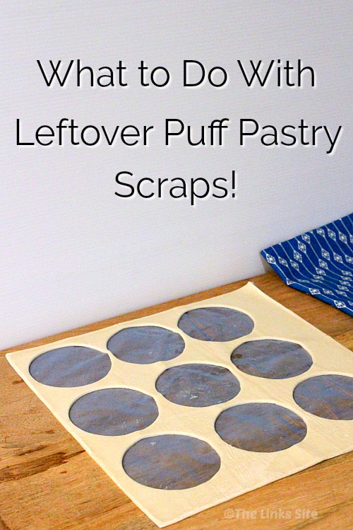 Leftovers from a sheet of puff pastry where circles have been cut from the sheet. The leftover pastry is lying on a wooden chopping board with a tea towel in the background. Text overlay says: What to Do With Leftover Puff Pastry Scraps!