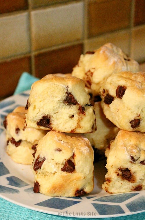 Blue and white plate topped with chocolate chip filled scones.