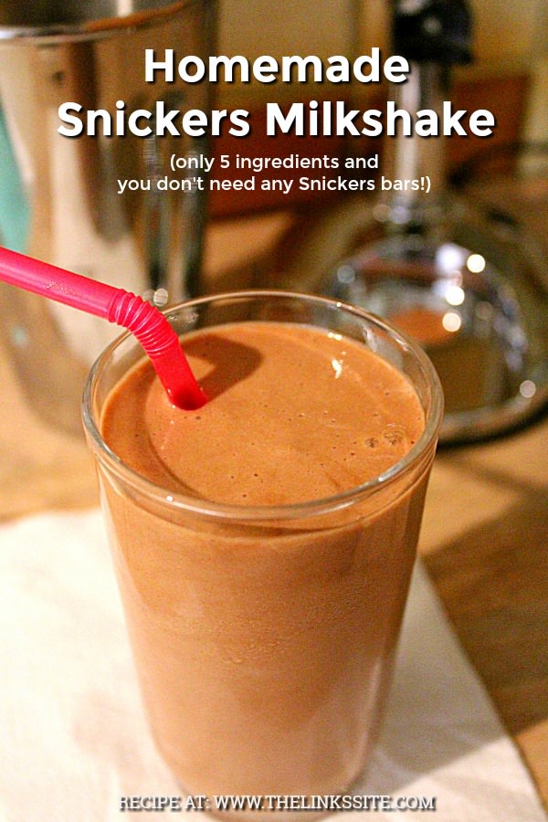 Milkshake in a glass with a pink straw. A milkshake maker can be seen in the background. Text overlay says: Homemade Snickers Milkshake (only 5 ingredients and you don’t need any snickers bars!).
