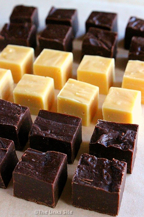 Three types of 2 ingredient fudge arranged in rows on a piece of baking paper. Chocolate fudge in foreground, caramel fudge in the middle and choc caramel fudge in the background.