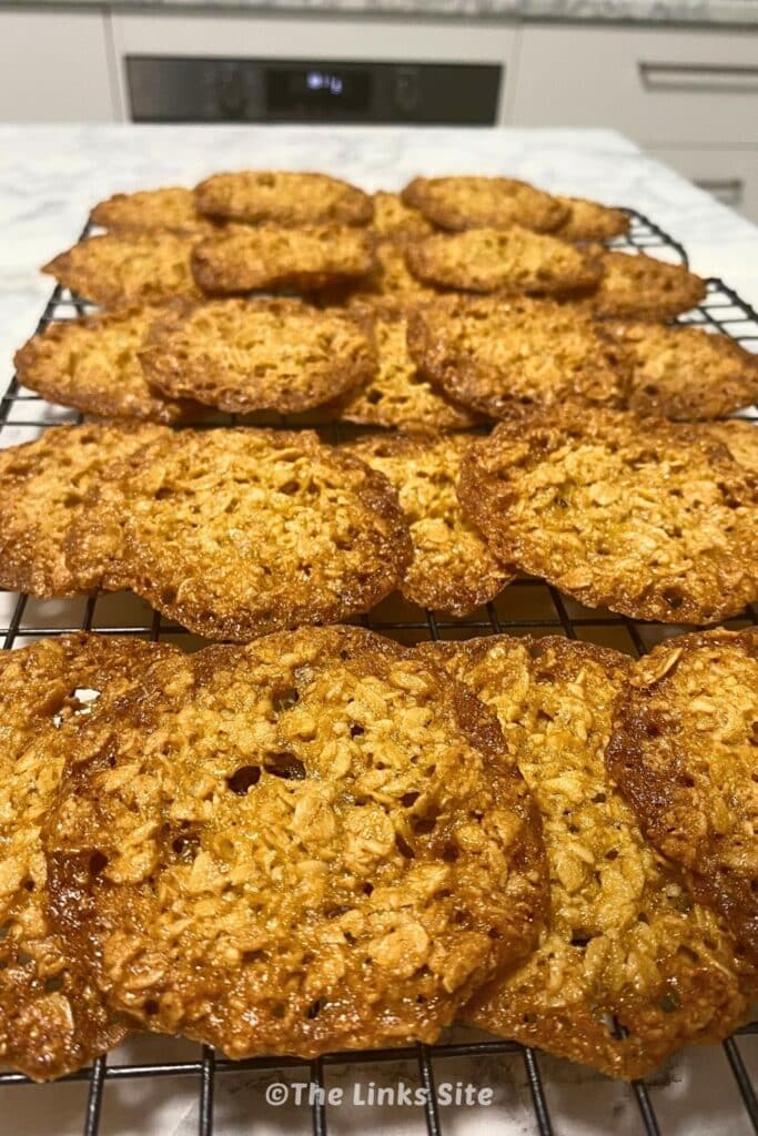 Stacked rows of biscuits on a wire rack.