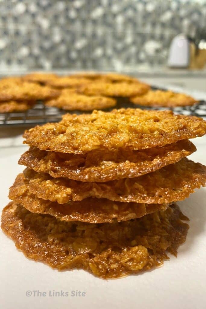 Stack of 5 biscuits with more seen in the background.