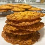 Stack of 5 biscuits with more seen in the background. Text overlay says ‘Rolled Oat Biscuits’.