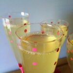 Mock champagne in a clear glass with decorative pint dots.