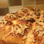 Garlic and herb bread cooling on a wire rack.
