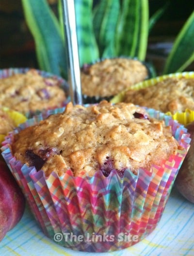 Plum Oat Muffins on a cake stand.