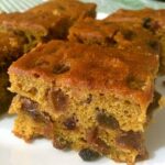 Pieces of pumpkin fruit cake on a white plate.